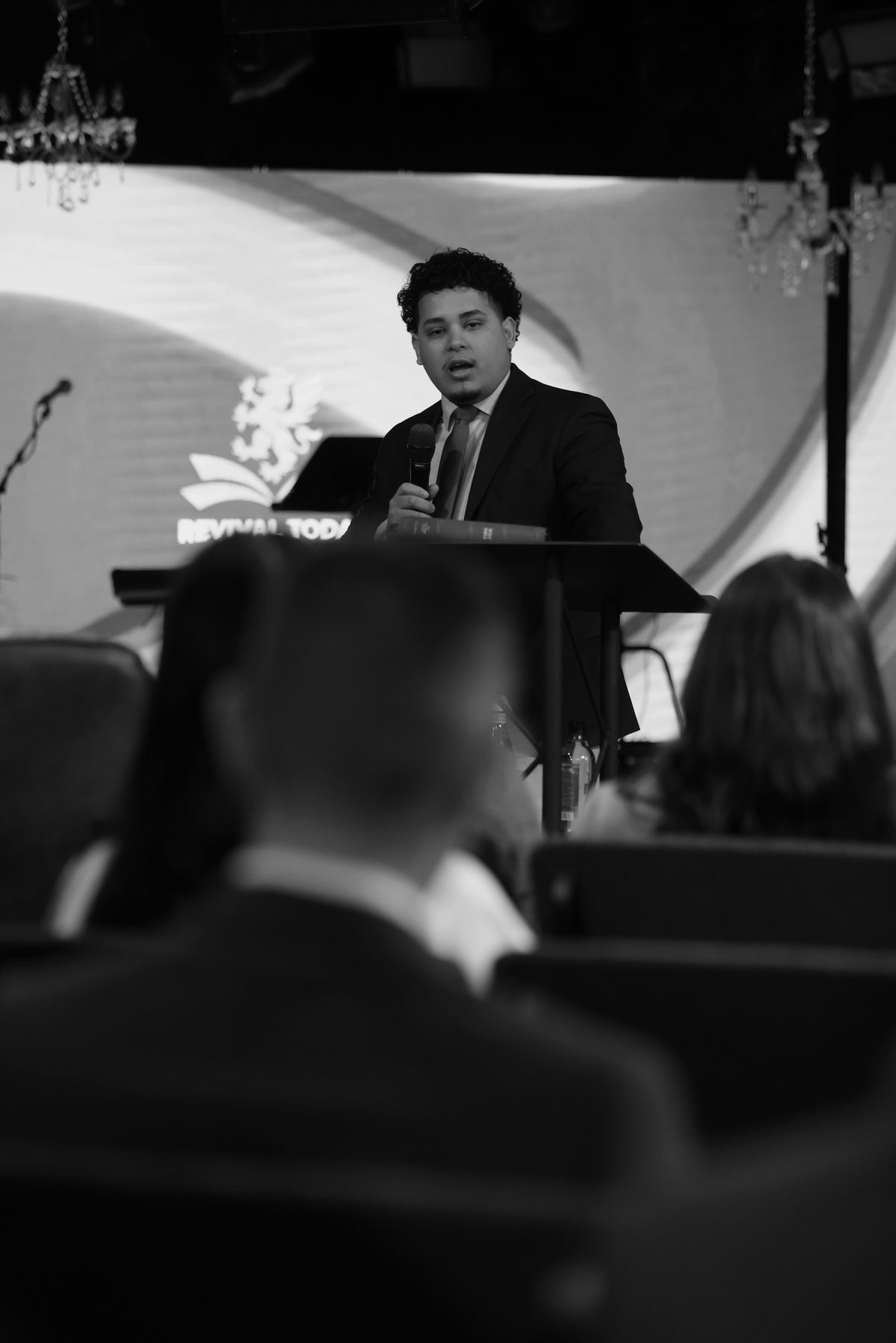 Evangelist Izaiah Diaz preaching at the Revival Today pulpit in black and white